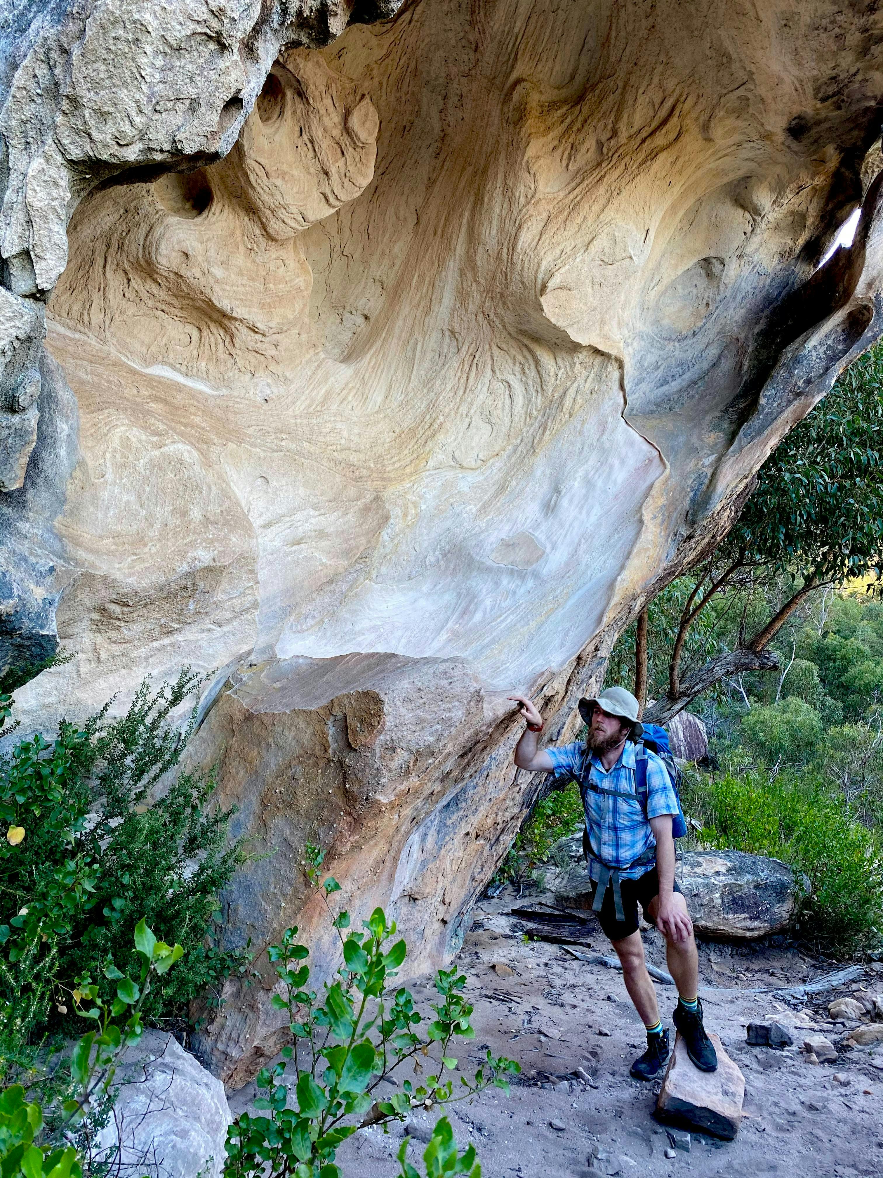 One of our guides discussing wind erosion on a fallen boulder in the Stapylton Amphitheater