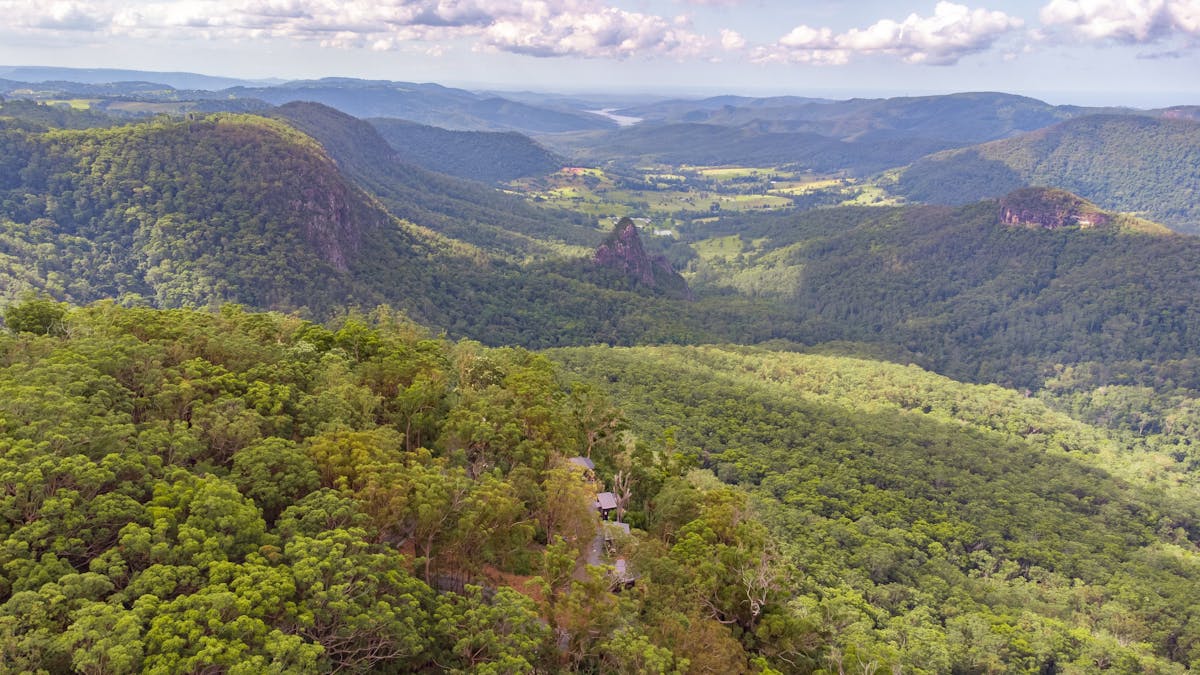 Aerial view of the Tiny Wild Houses set among the forest at Binna Burra..