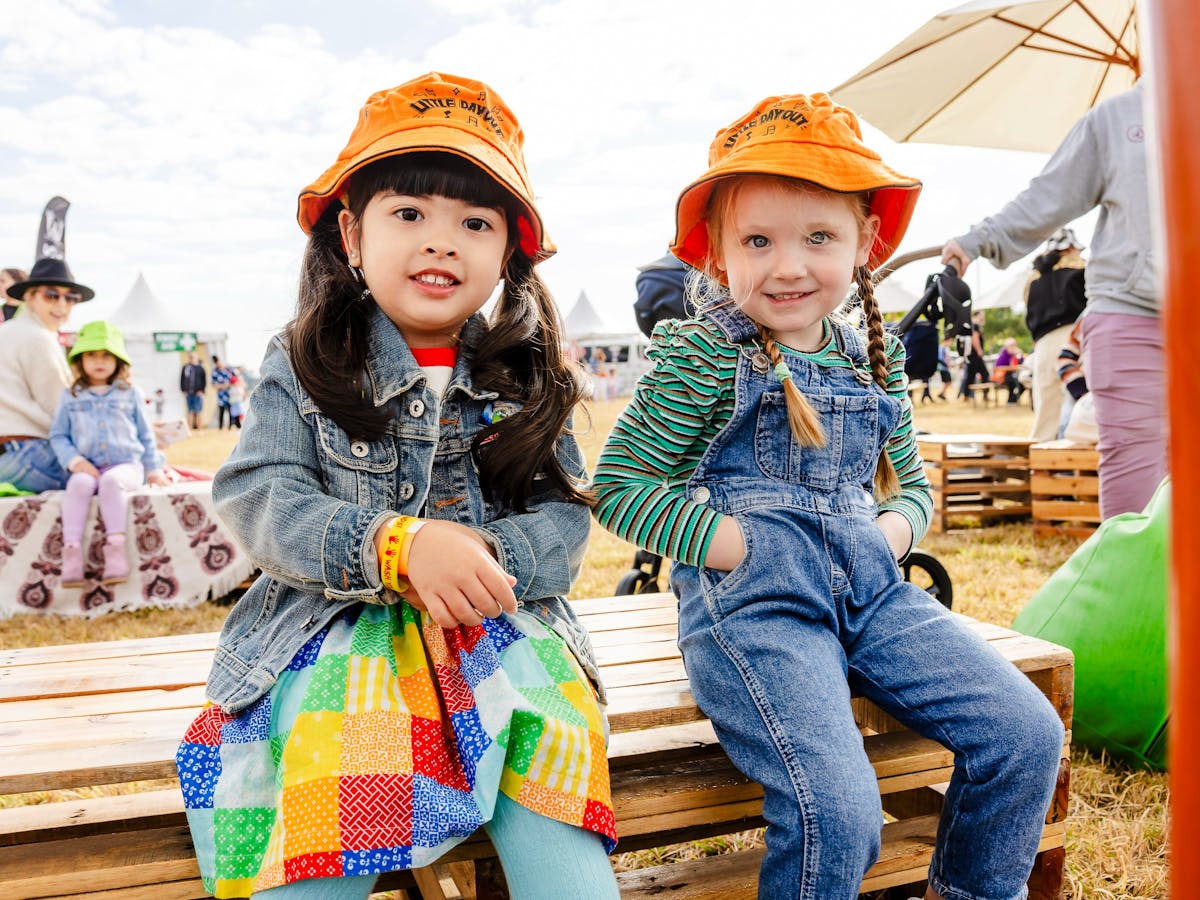 Kids sitting on crates at a festival