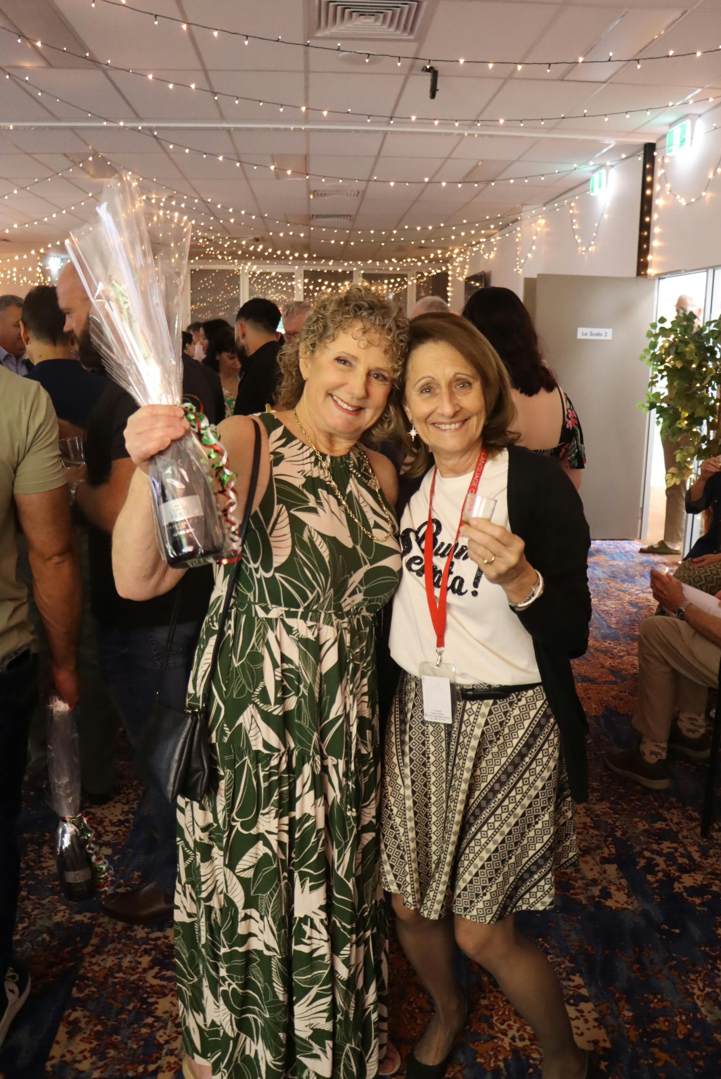 winner of the wine raffle with a staff member