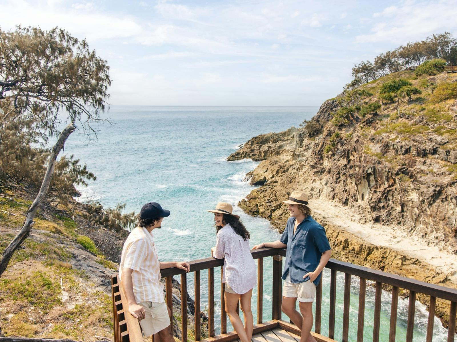 Tourists pausing at the top of the stairs leading down to the beach