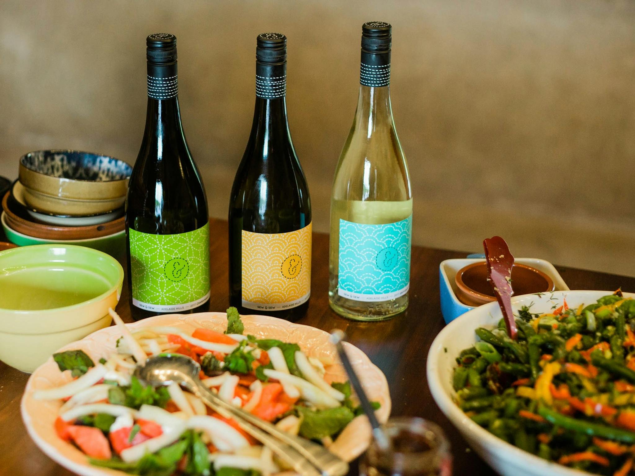 Inside the cellar door looking at a table filled with delicious salads and bottles of Sew & Sew wine