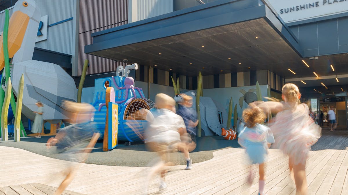 Children running towards outdoor playground