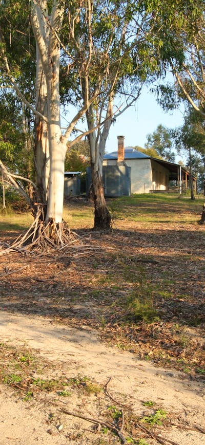 2 people walking on track in Australian bush to heritage property
