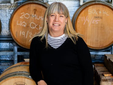 Winemaker leaning on wine barrels Winemaker leaning on wine barrels