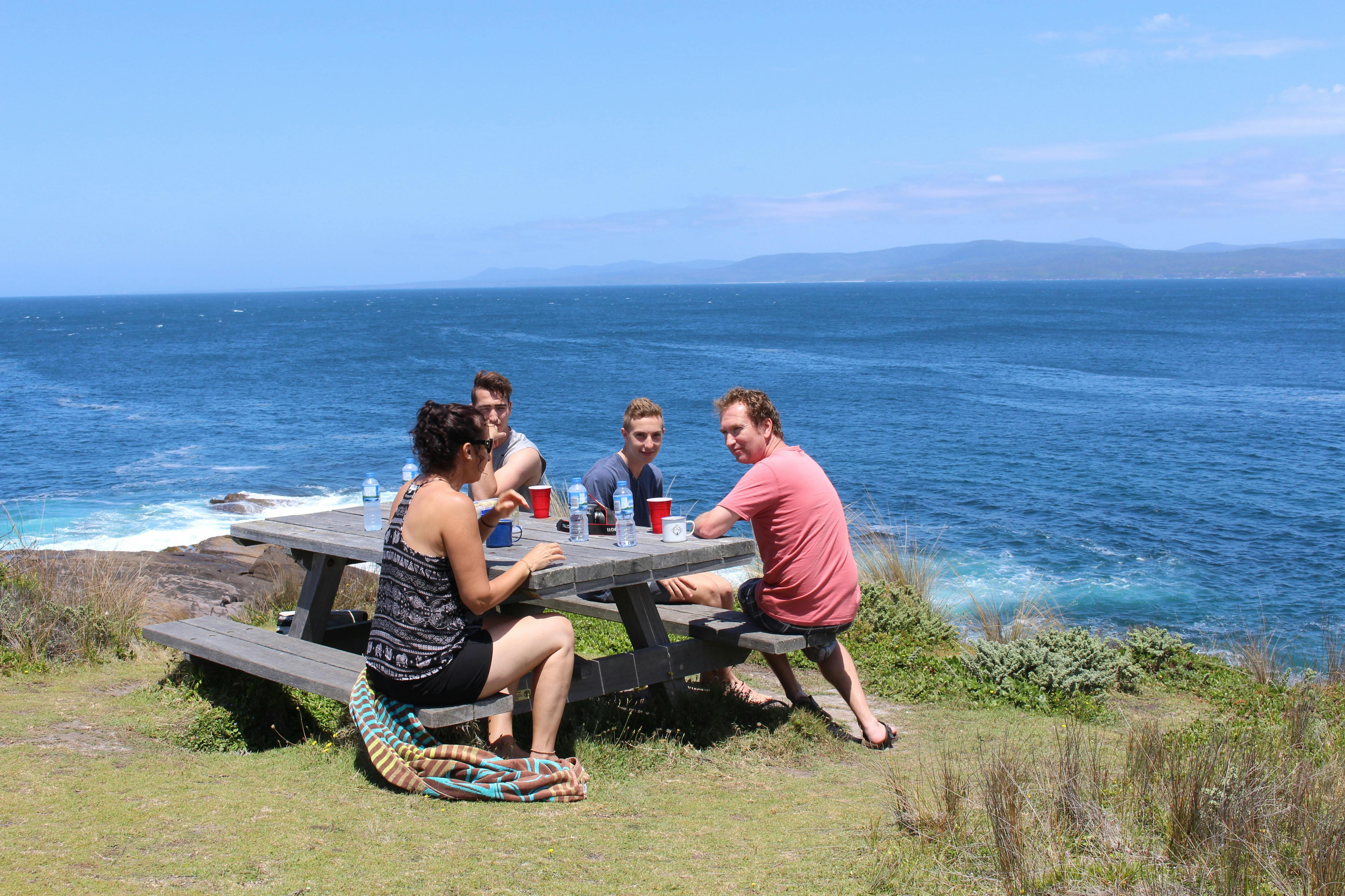 Family enjoying lunch overlooking the ocean near Greencape Lighthouse