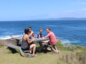 Family enjoying lunch overlooking the ocean near Greencape Lighthouse