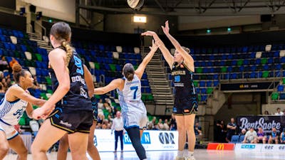 UC Capitals player shooting the basketball while a defender closes in.