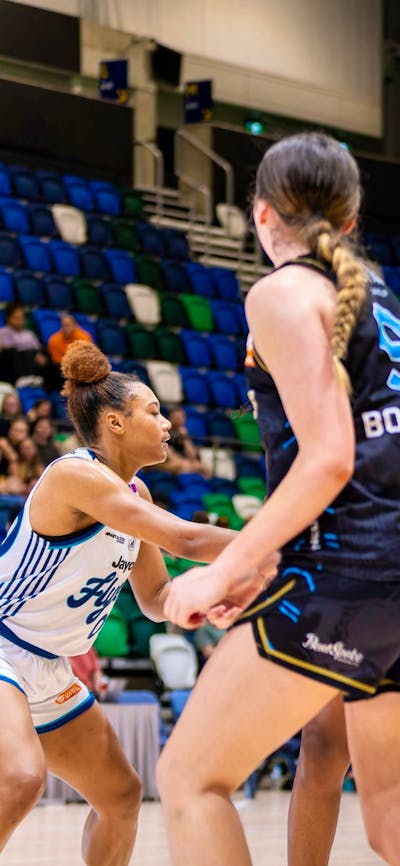 UC Capitals player shooting the basketball while a defender closes in.