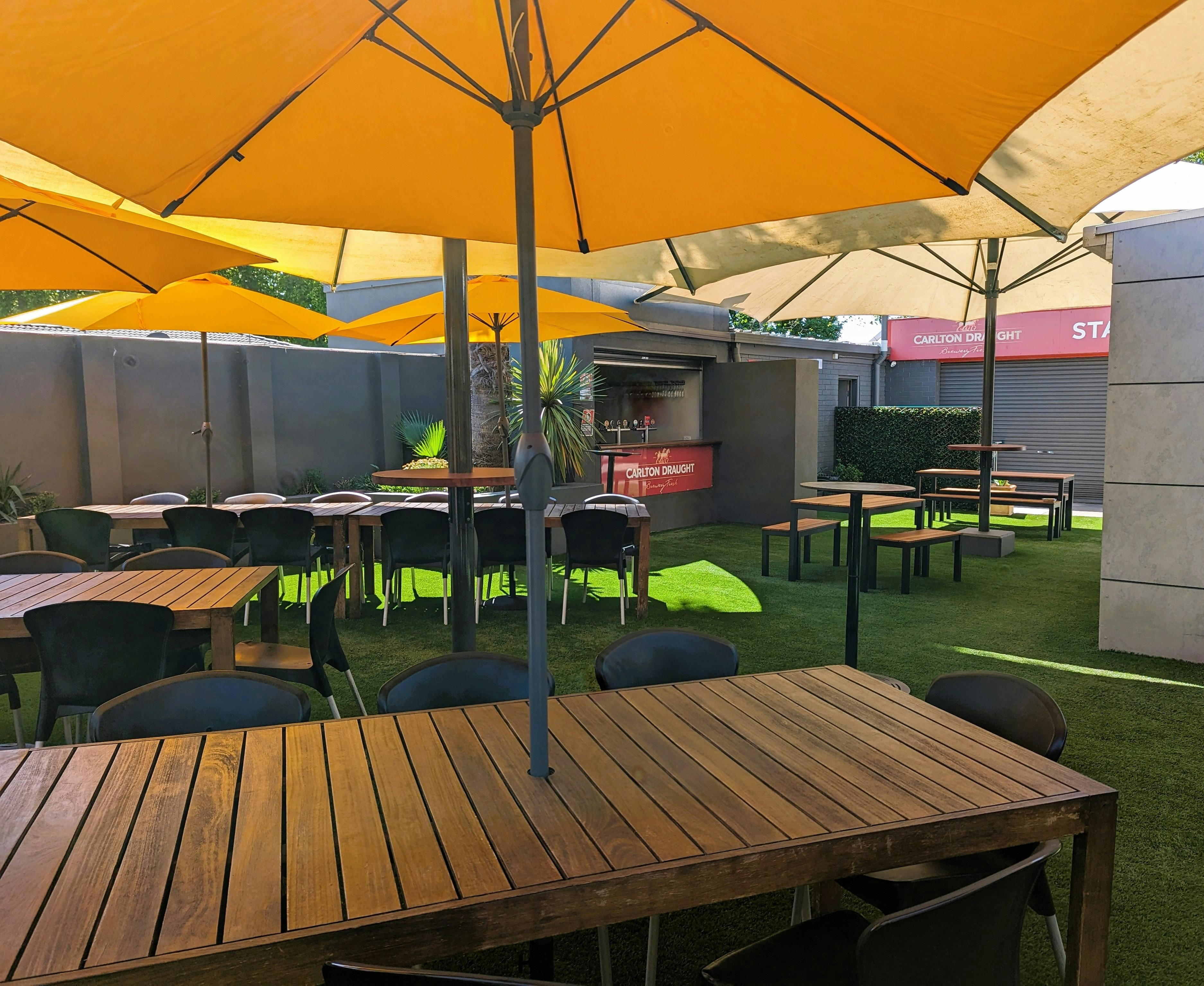 Outdoor seating area shaded by large umbrella's
