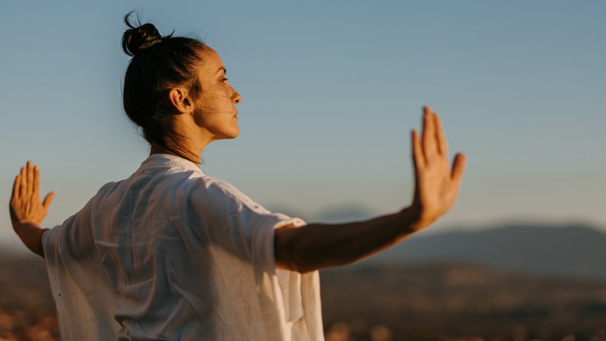 Woman standing outside doing chi kung
