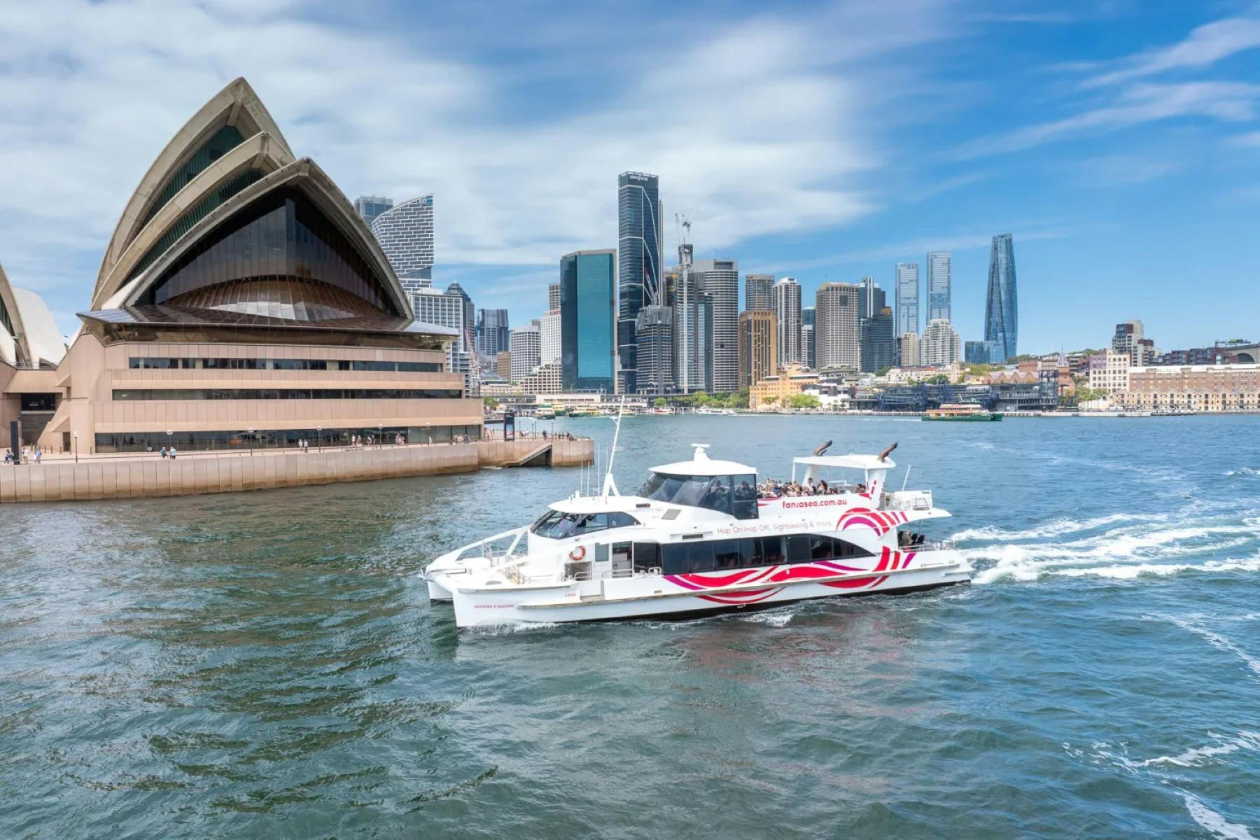 sightseeing boat cruising past the Sydney Opera House