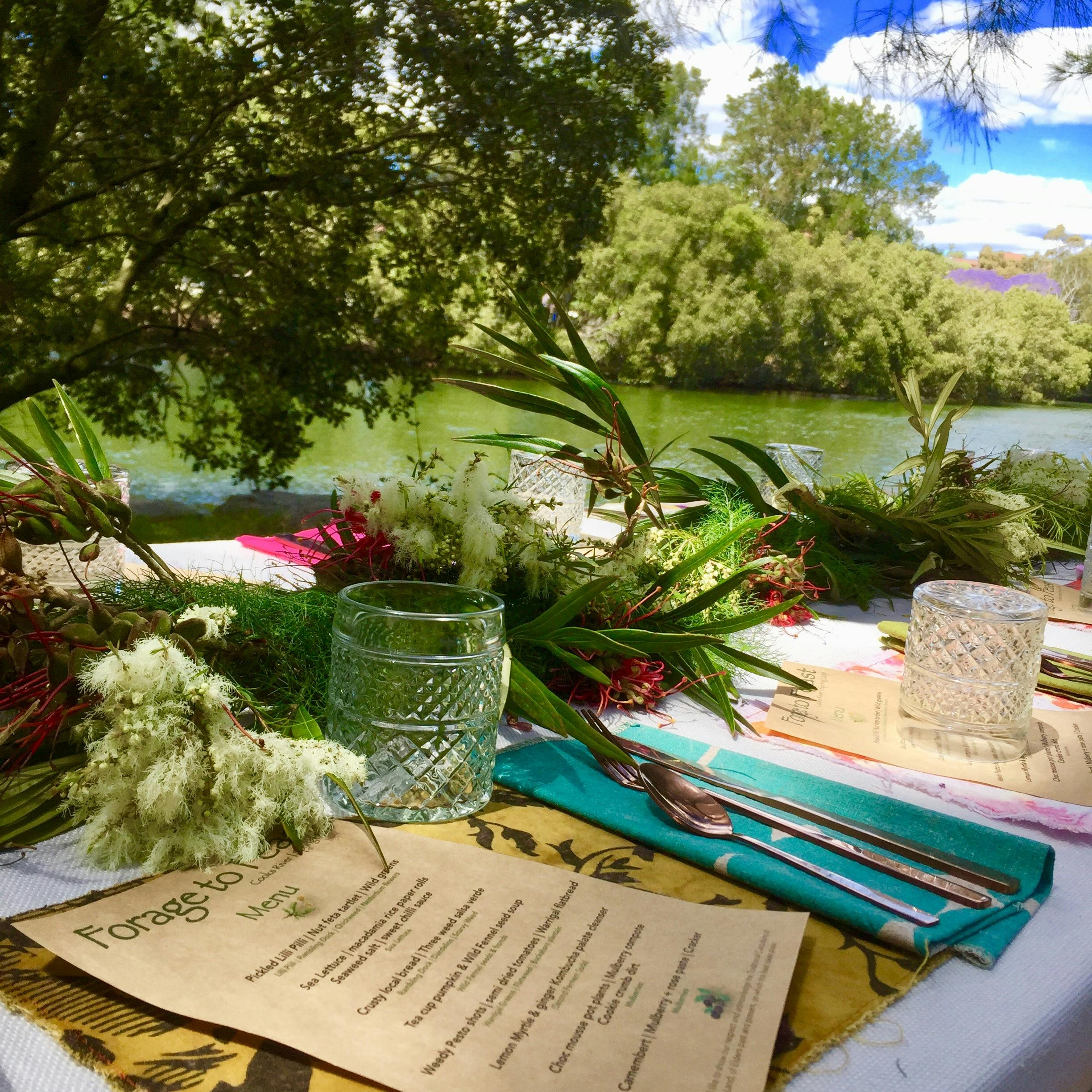 Long table by the river with a feast