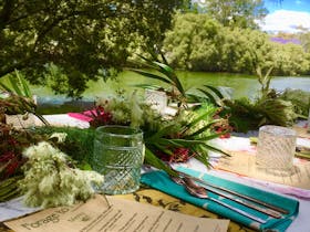 Long table by the river with a feast