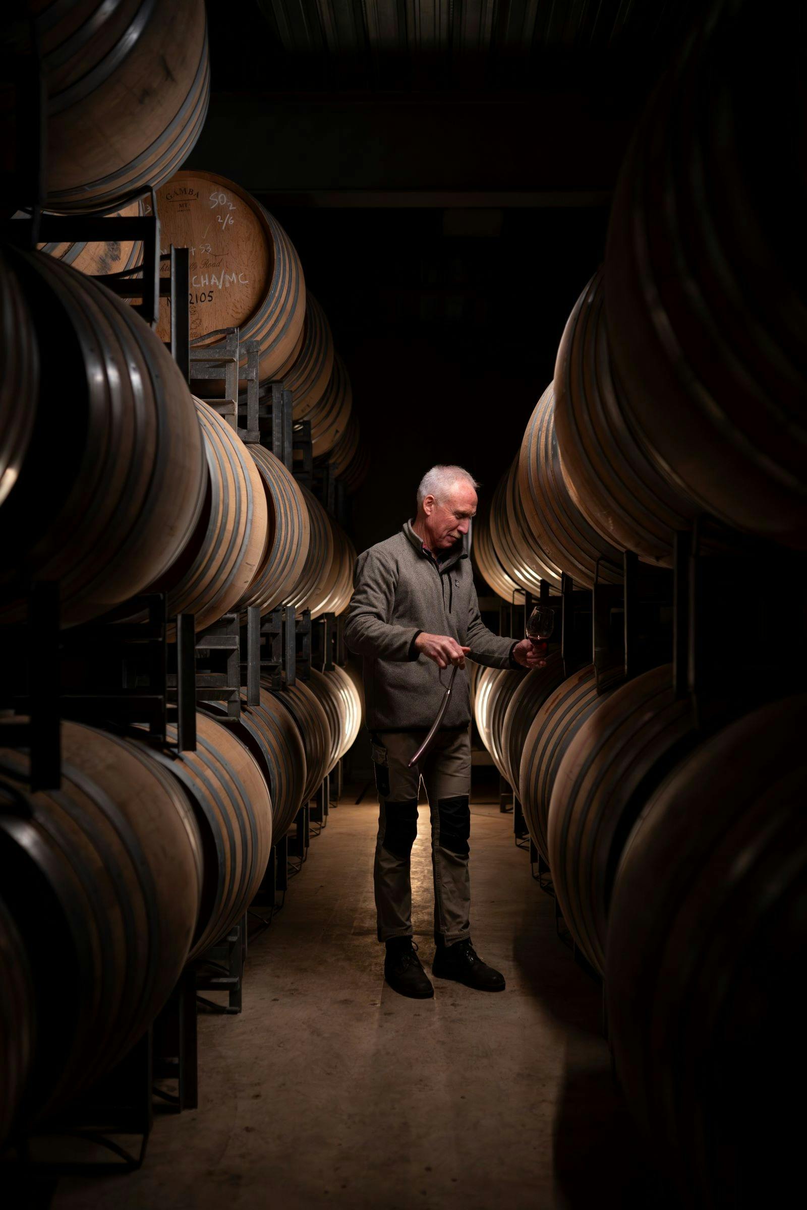 Mark Walpole, in the barrel room, tasting red wine