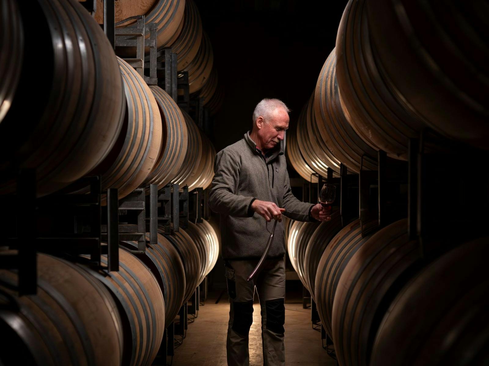 Mark Walpole, in the barrel room, tasting red wine