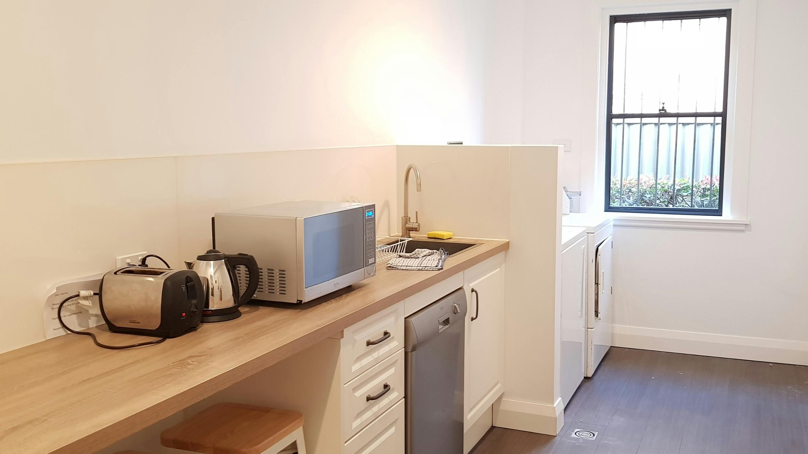 Shared guest kitchen and guest laundry