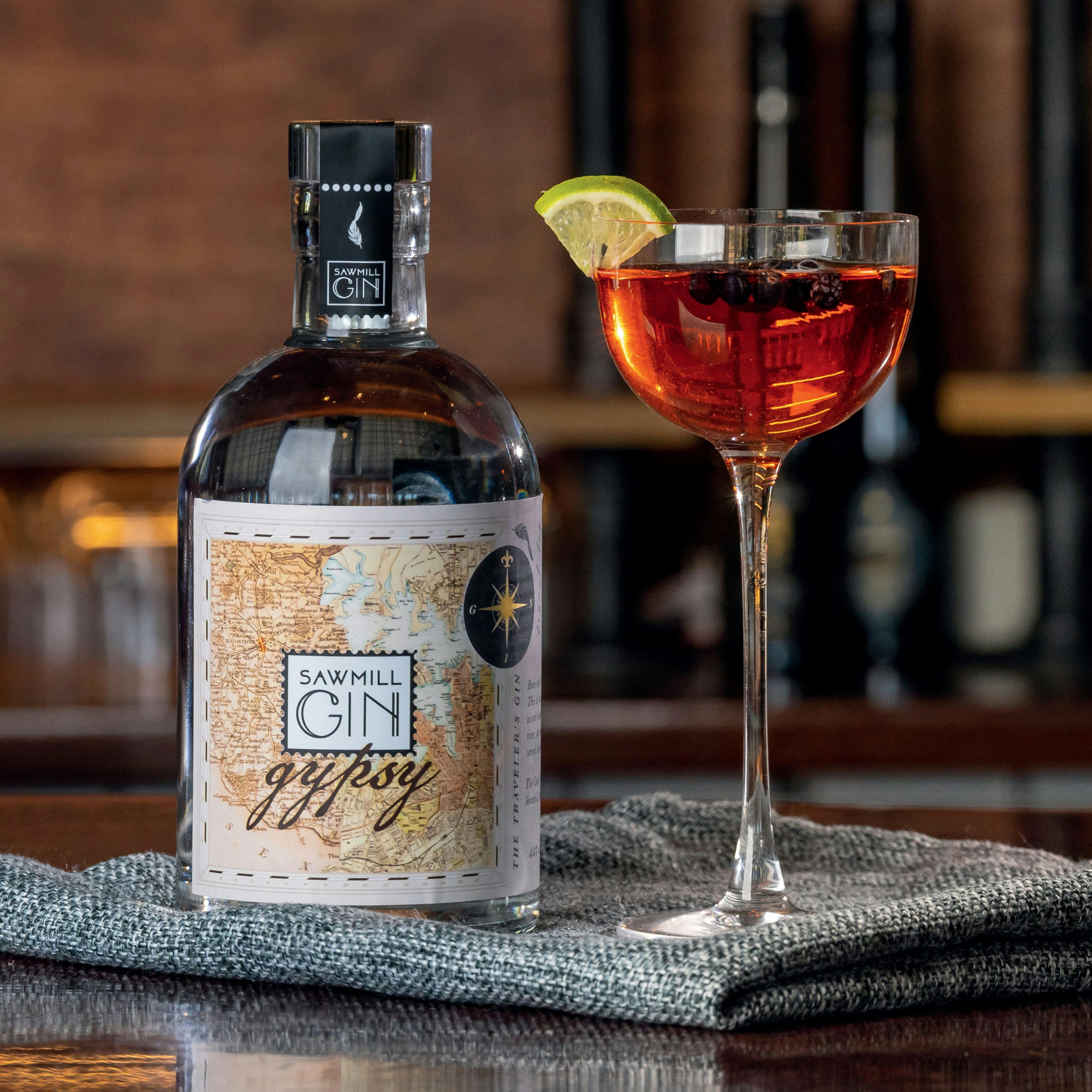 A bottle of Gin and a small, long stemmed cocktail glass