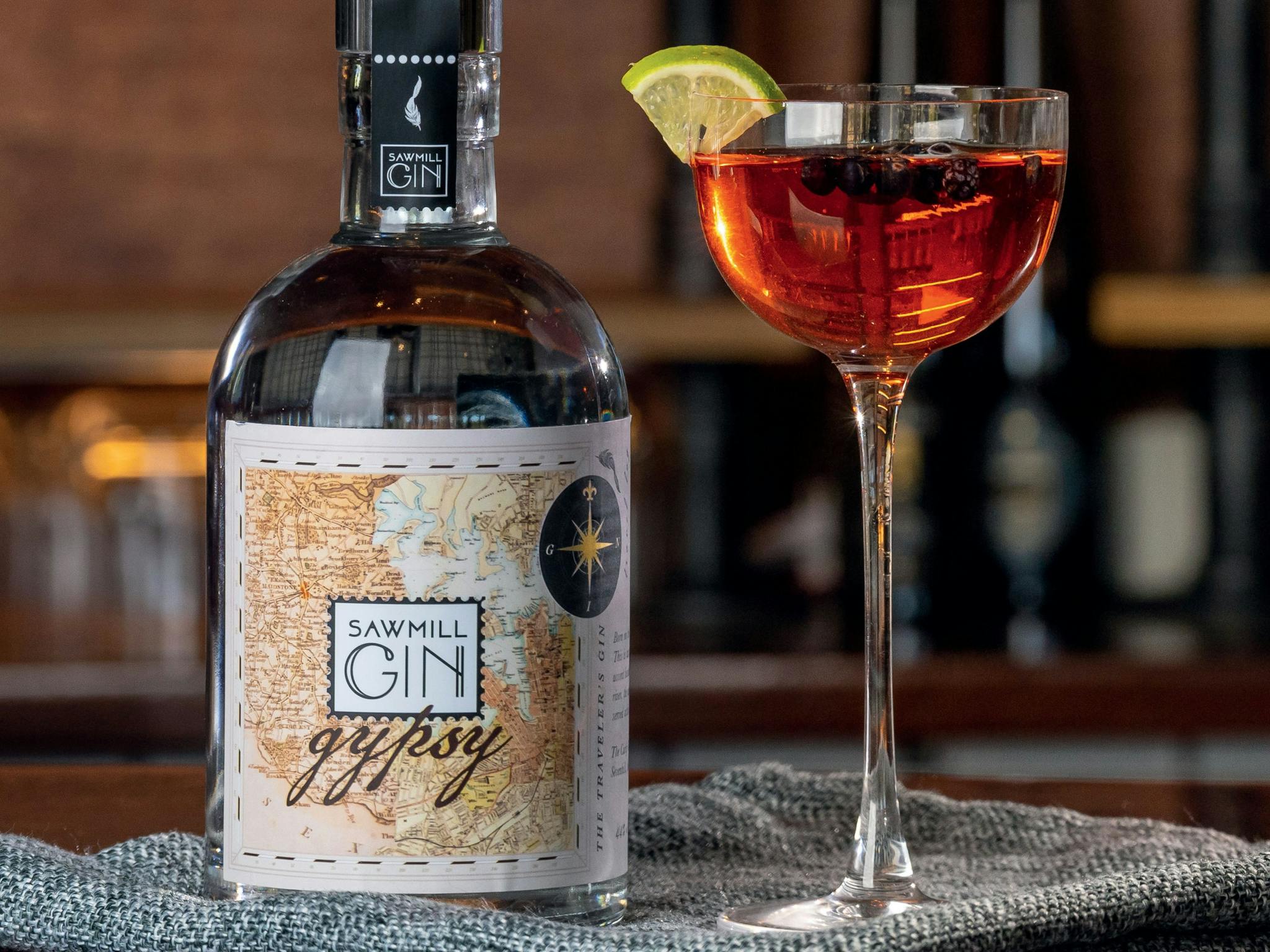 A bottle of Gin and a small, long stemmed cocktail glass