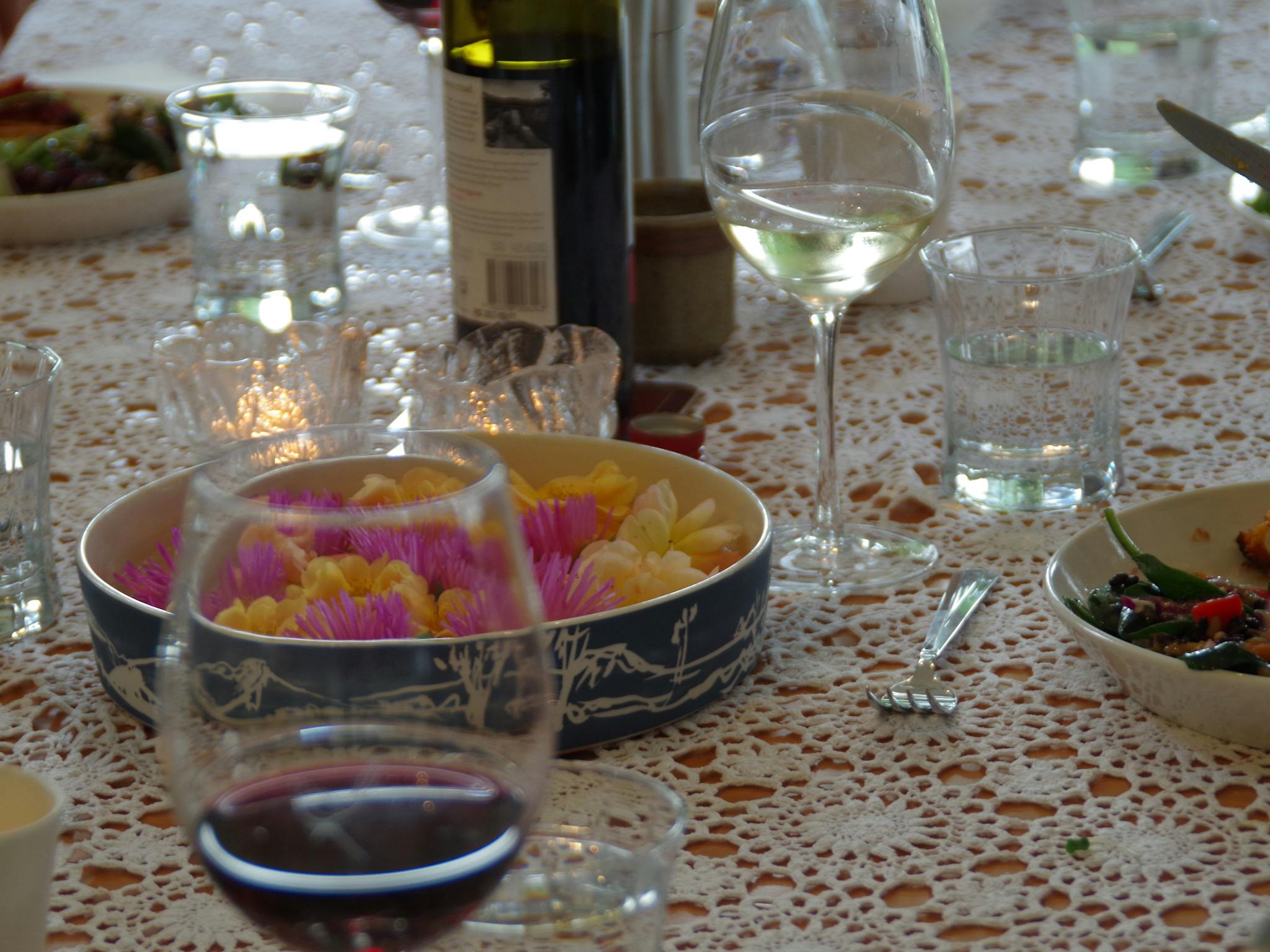 A table set with plates, glasses and food