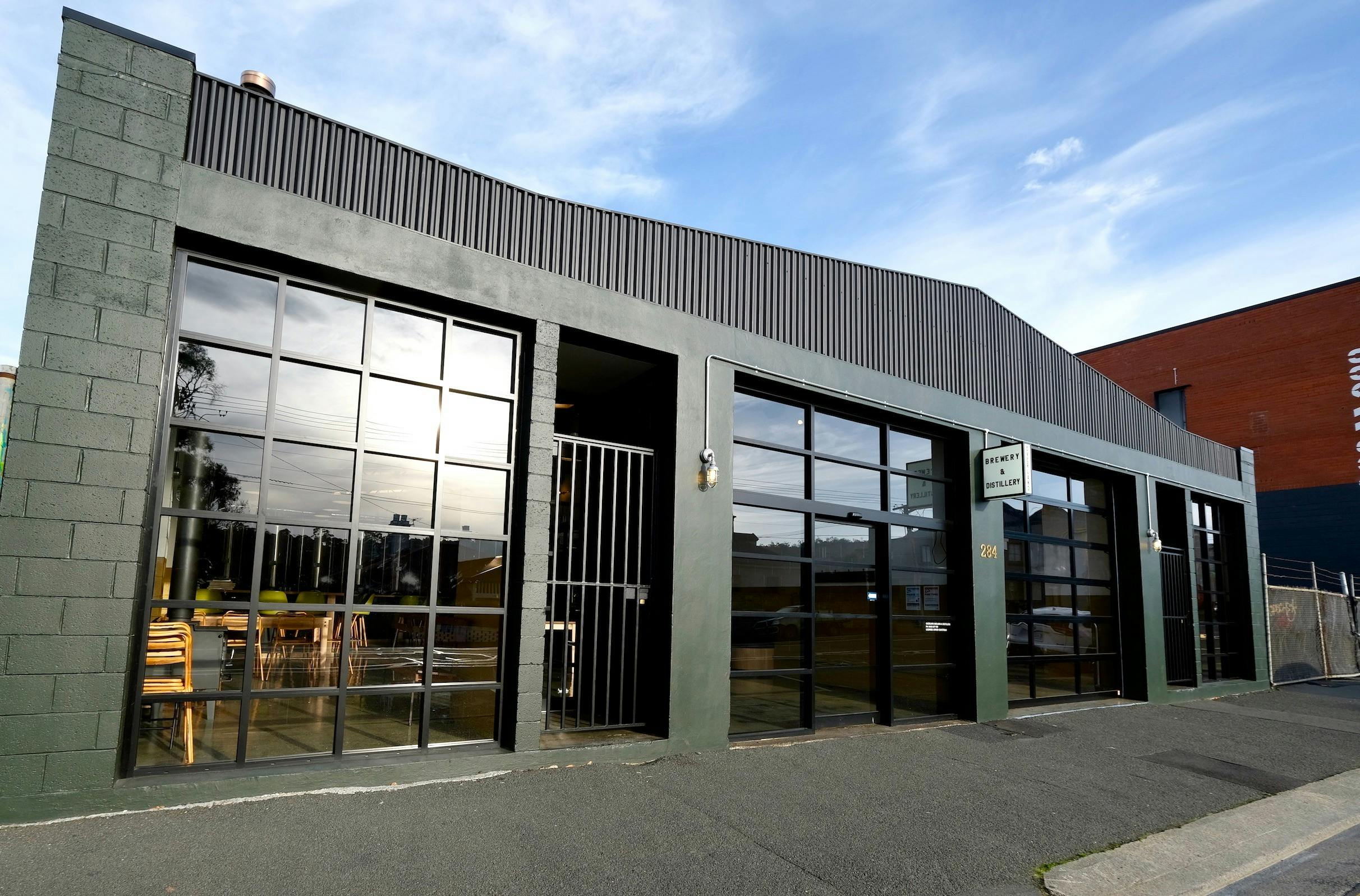 Exterior of Overland building is dark green with industrial windows