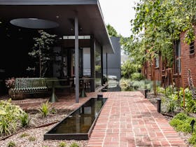 An accessible path, water feature and garden