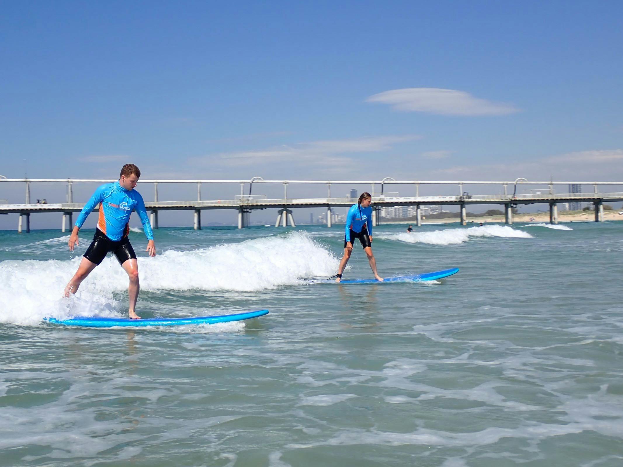 Two surfers sharing a wave, Get Wet Surf School Gold Coast