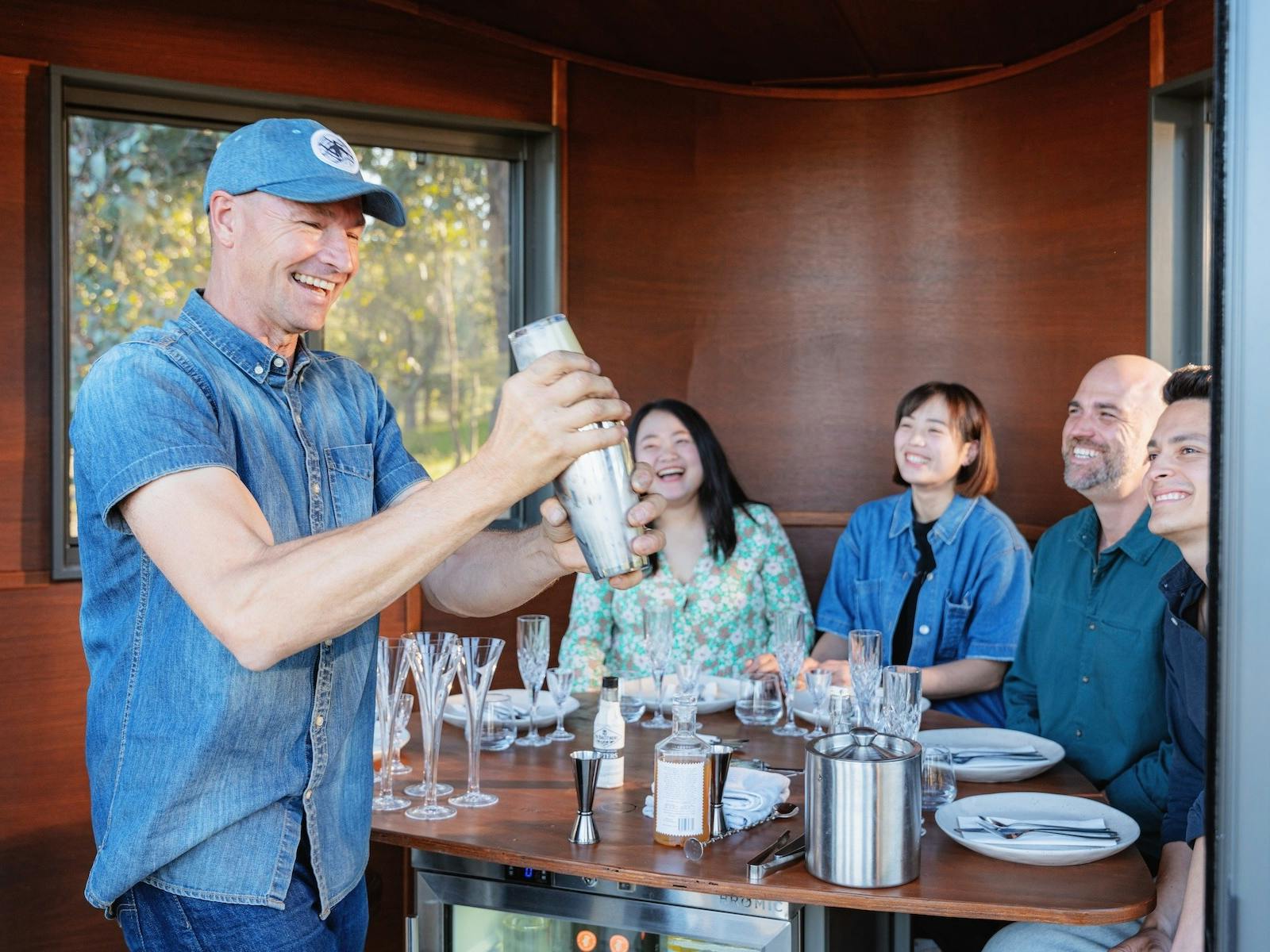 Hank shakes cocktails for guests inside the Swiftcrest Tasting Pod experience.