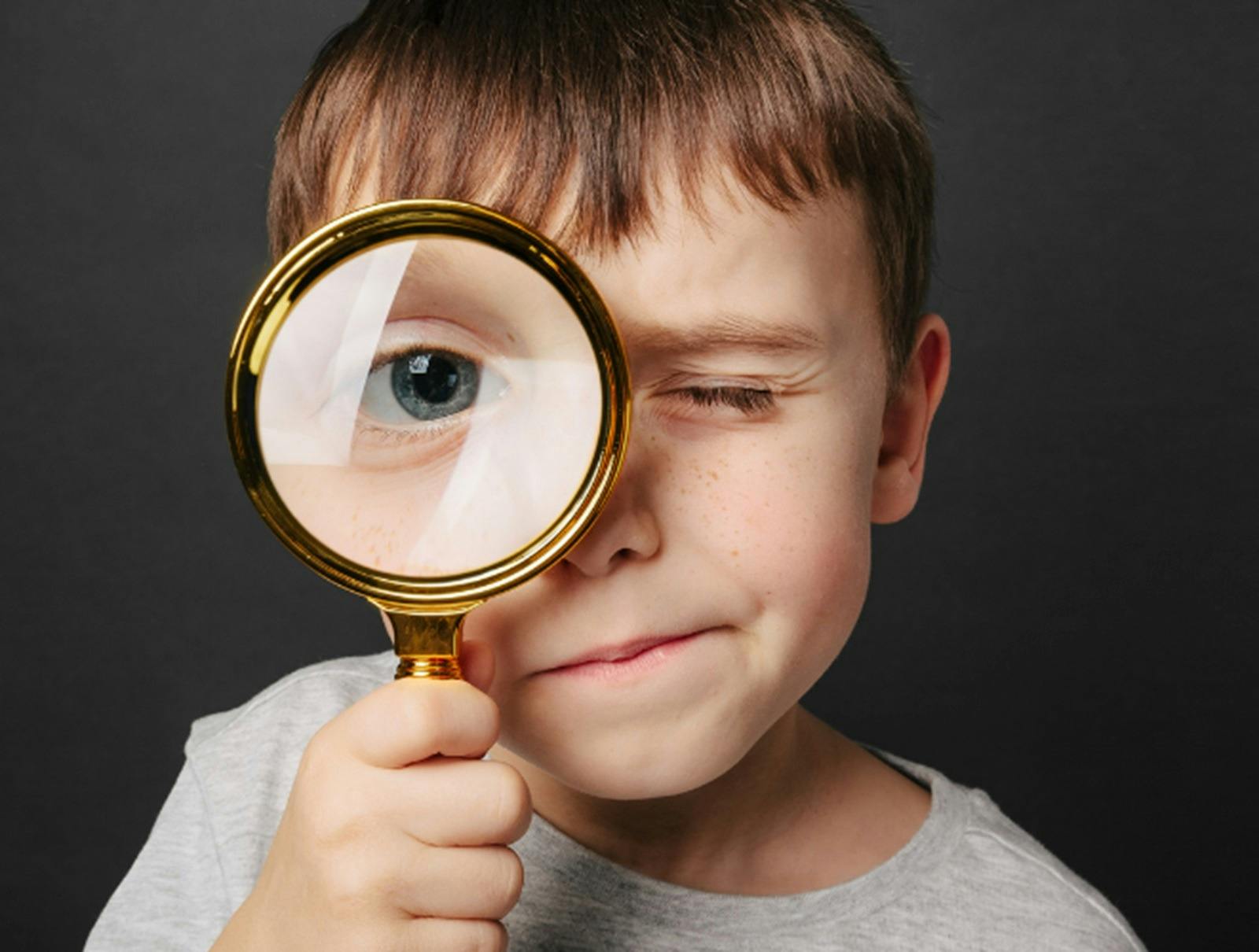 Child Holding Magnifying Glass