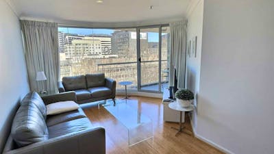 Bright open-plan apartment interior with large windows.