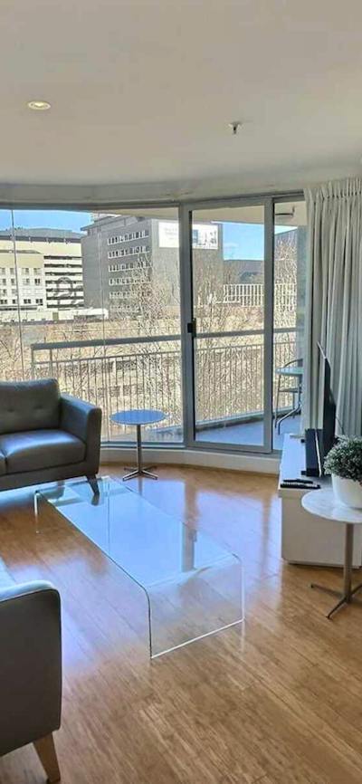 Bright open-plan apartment interior with large windows.