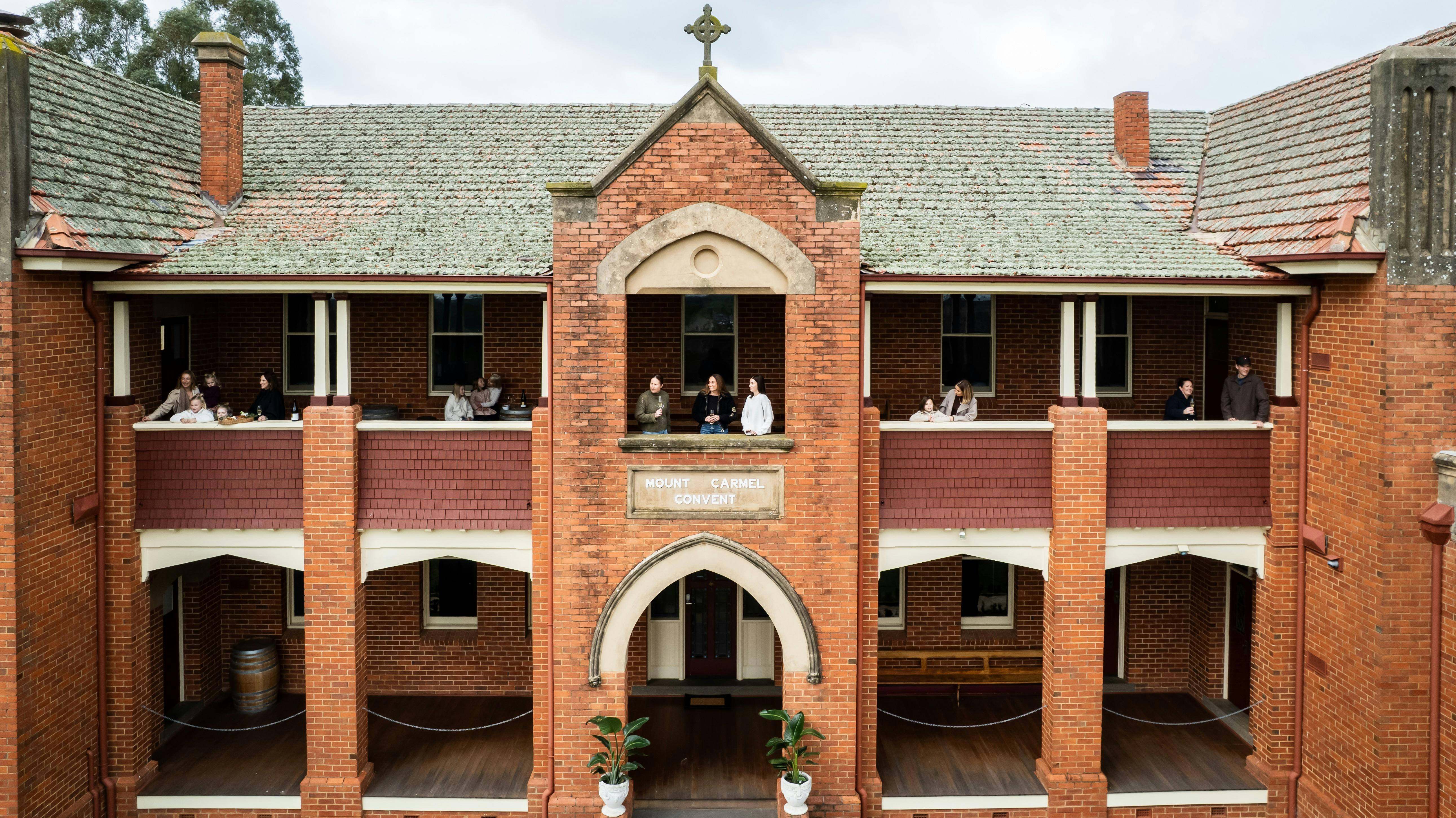 a group of people standing on a balcony watching the view