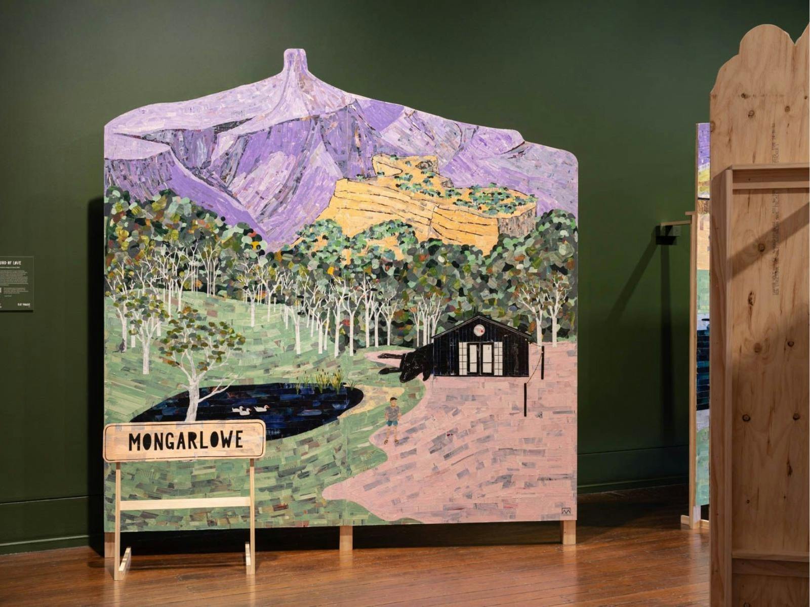 ghostworked collage on board depicting Mongarlowe. A house, pond and mountain range are featured.