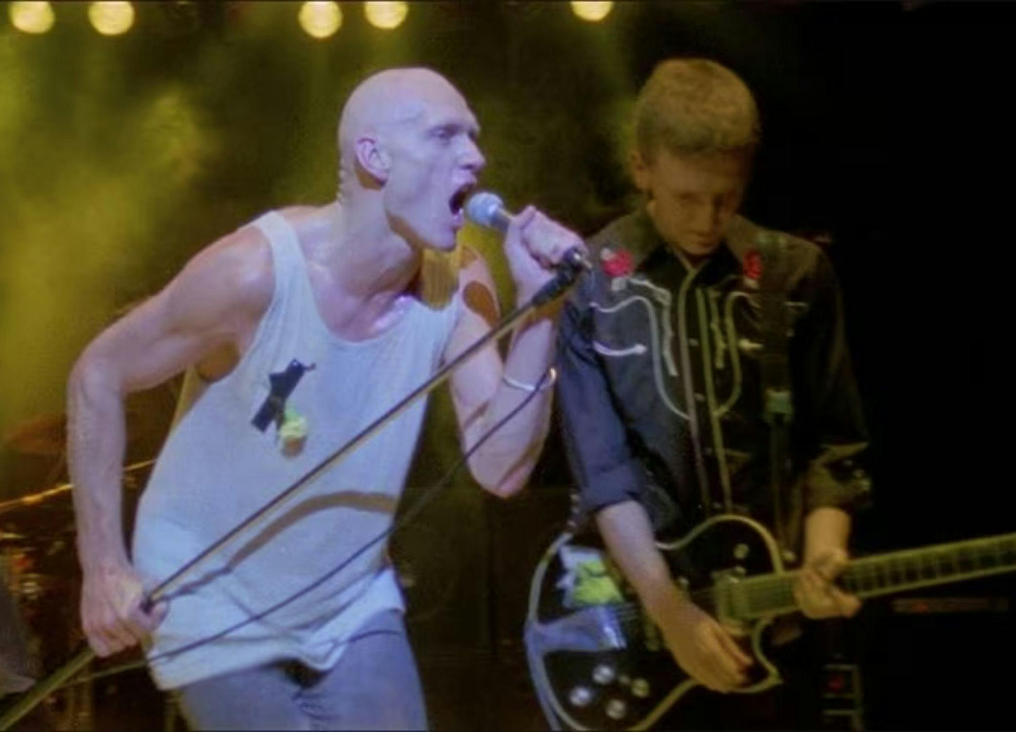 Men on stage playing music