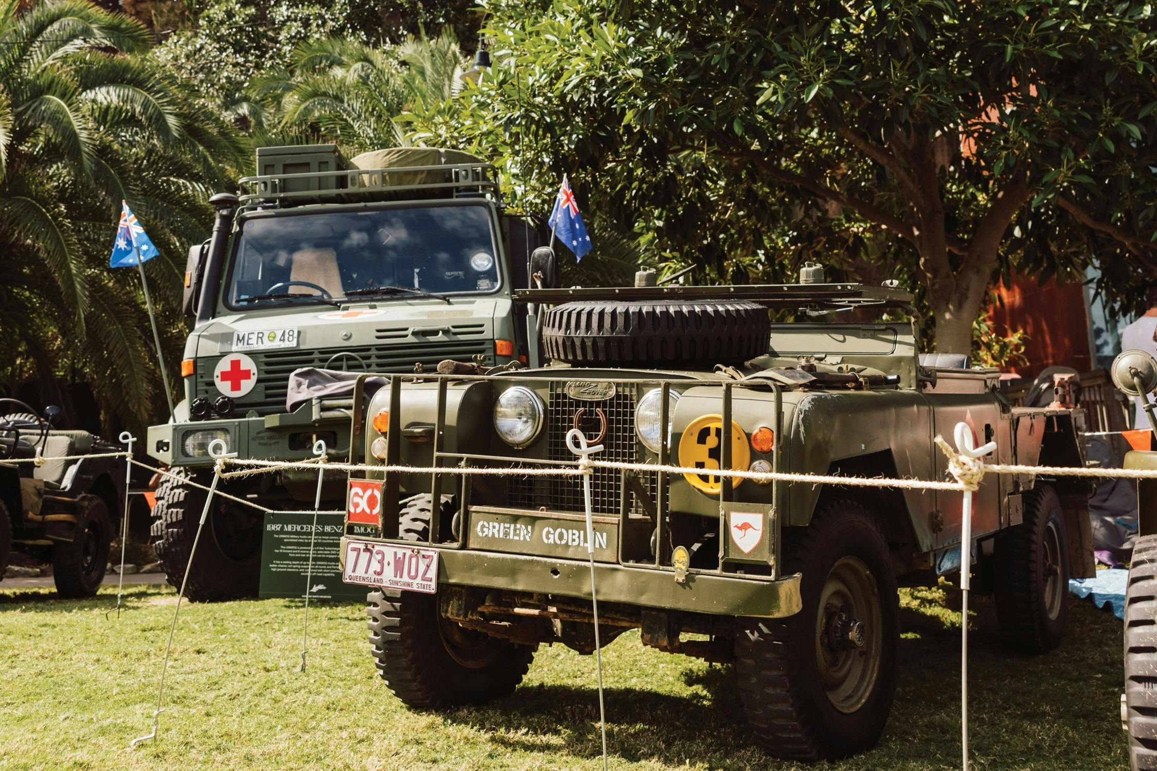 Vintage military vehicles are displayed on the lawn at Howard Smith Wharves