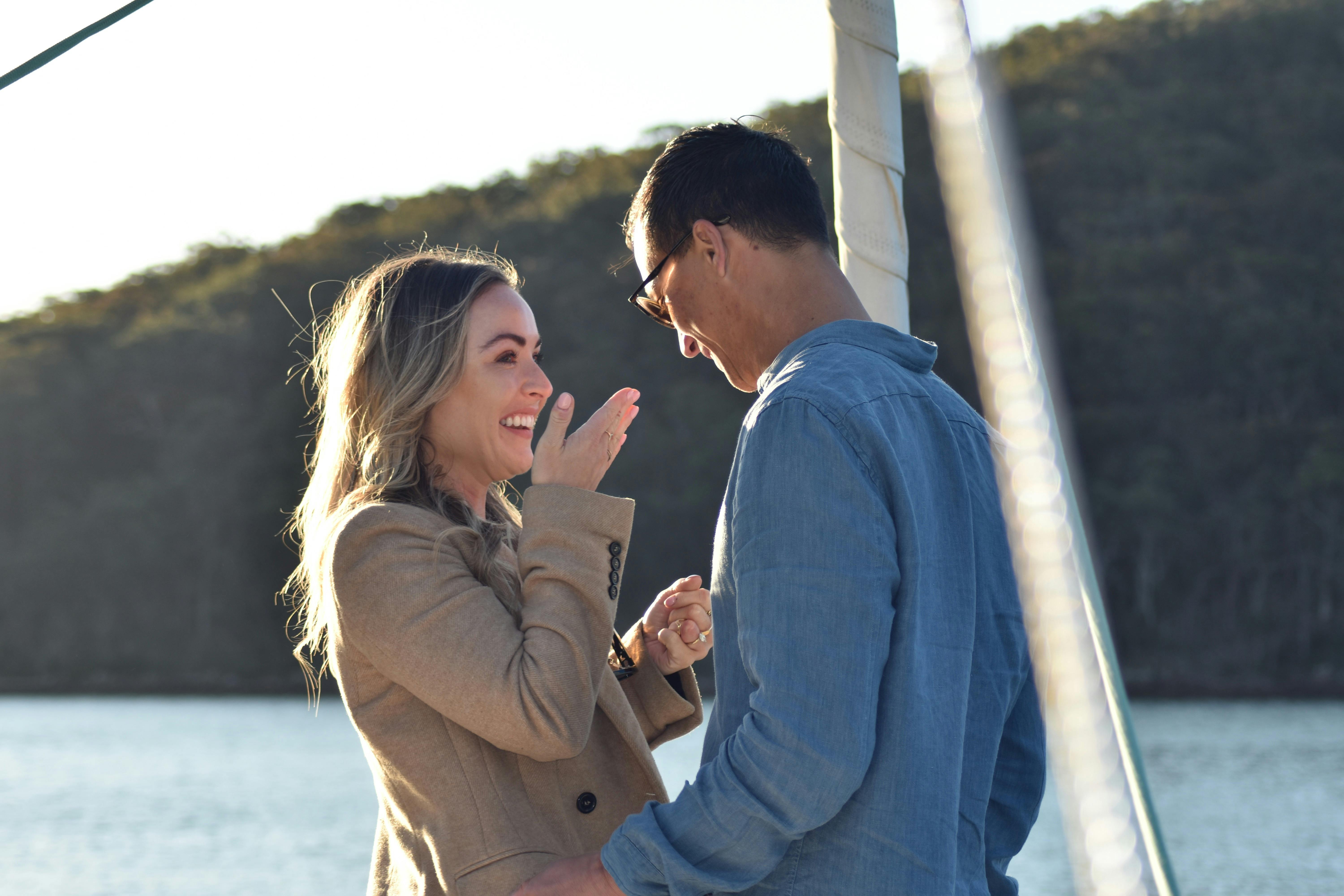 Couple on the bow of the boat with the woman smiling