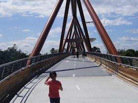 Boy walking over bridge