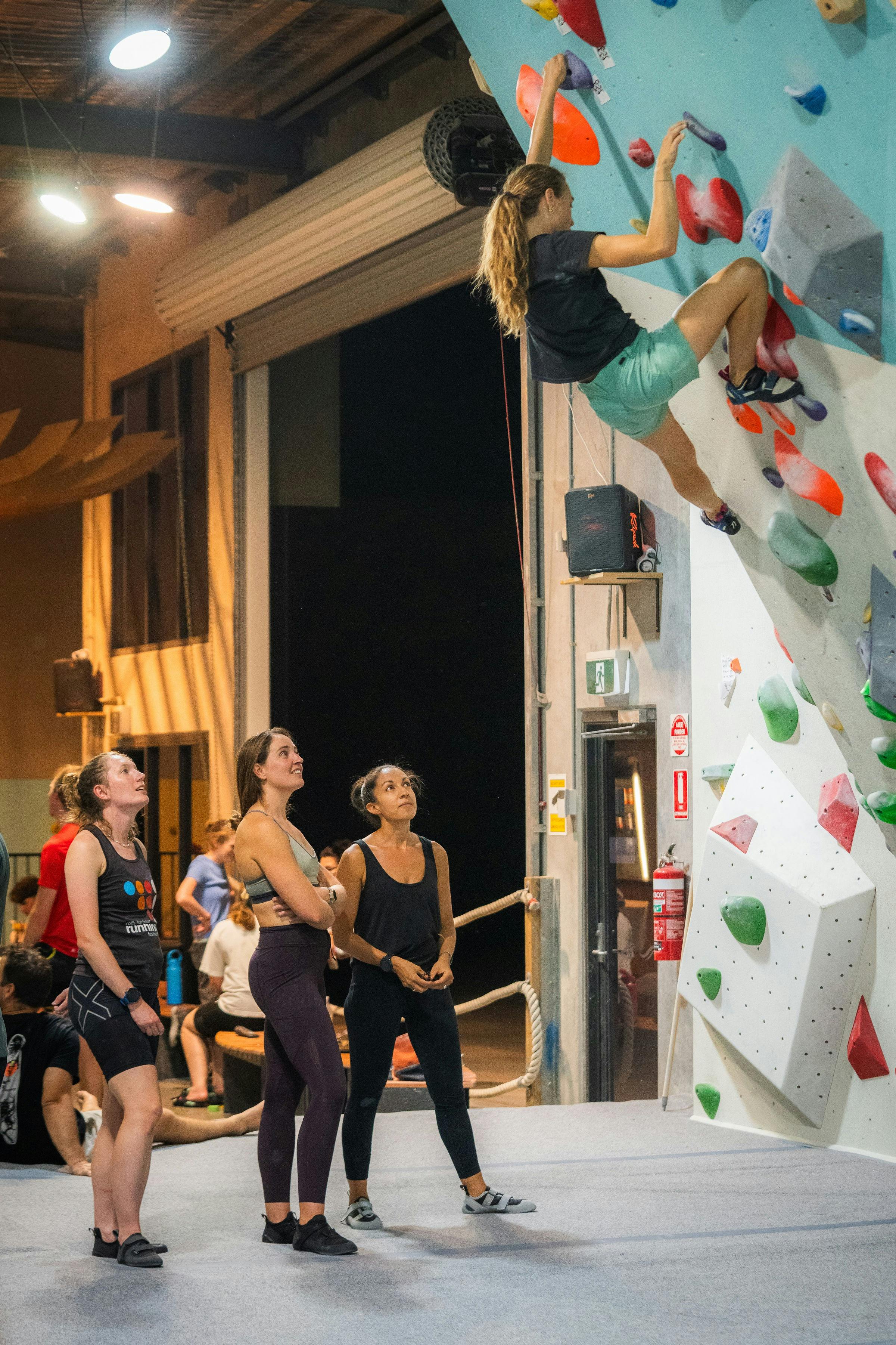 An instructor is demonstrating a climb to some climbers