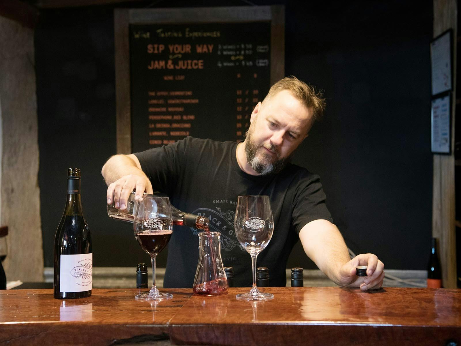 Winemaker Hadyn Black pouring a tasting at the Black & Ginger Wine Shed