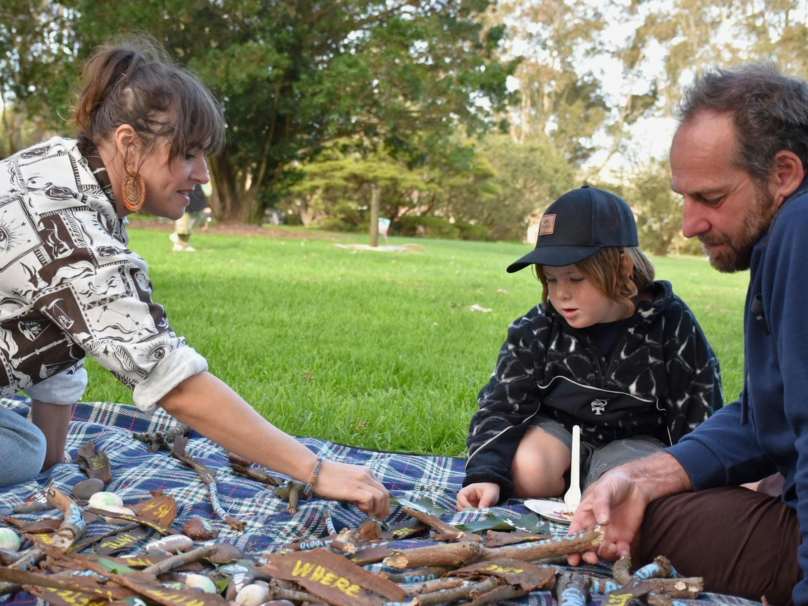 Educator talking to father and son about nature inspried poems in garden