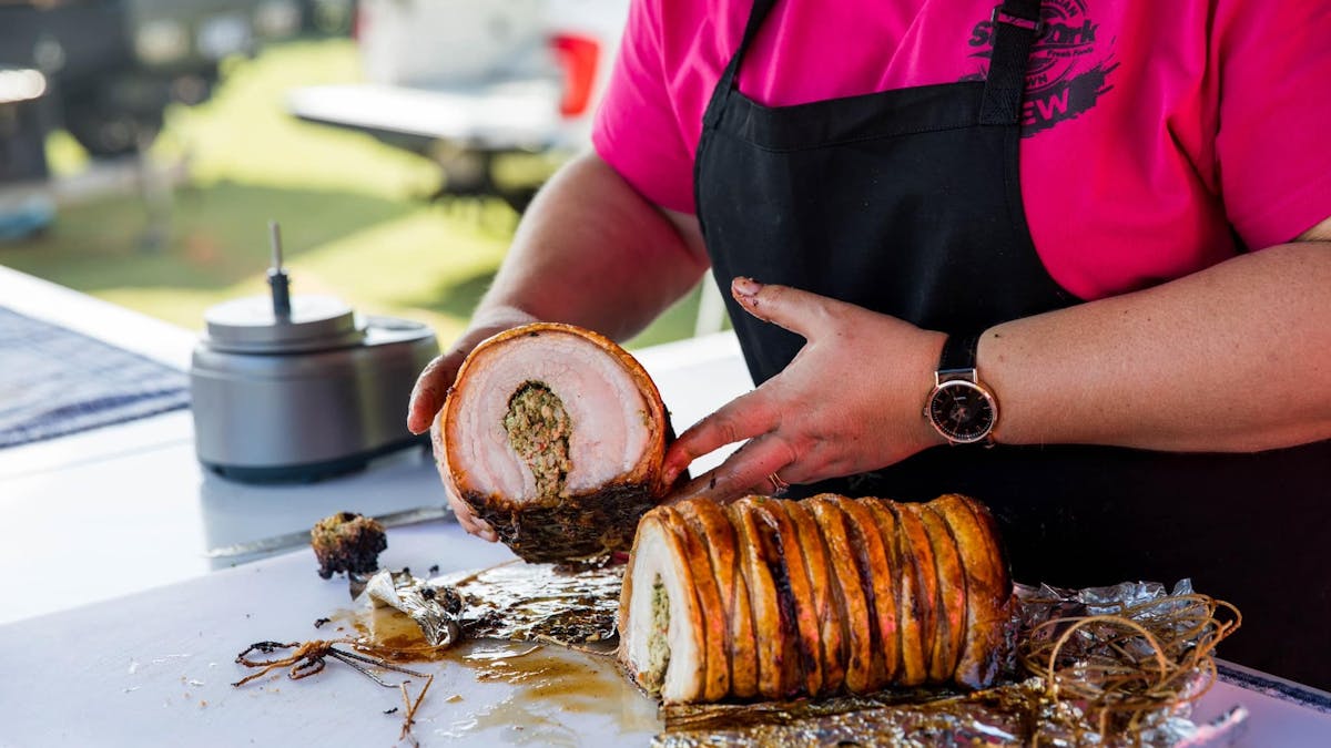 Meat Noosa BBQ Festival – Pitmaster Smoking Brisket – A skilled pitmaster tending to a smoker at Mea