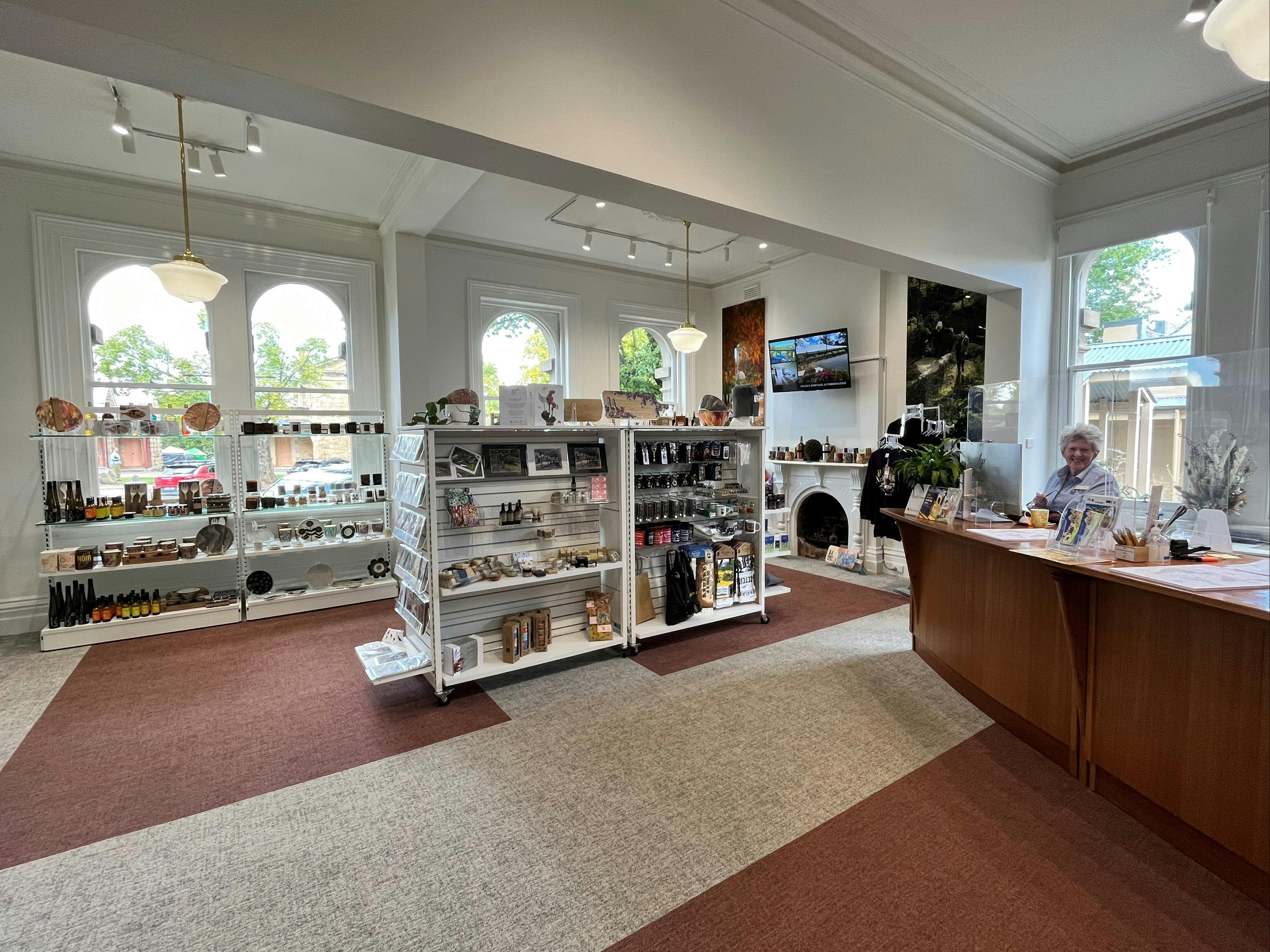 Inside room of centre. large wooden counter and retail displays