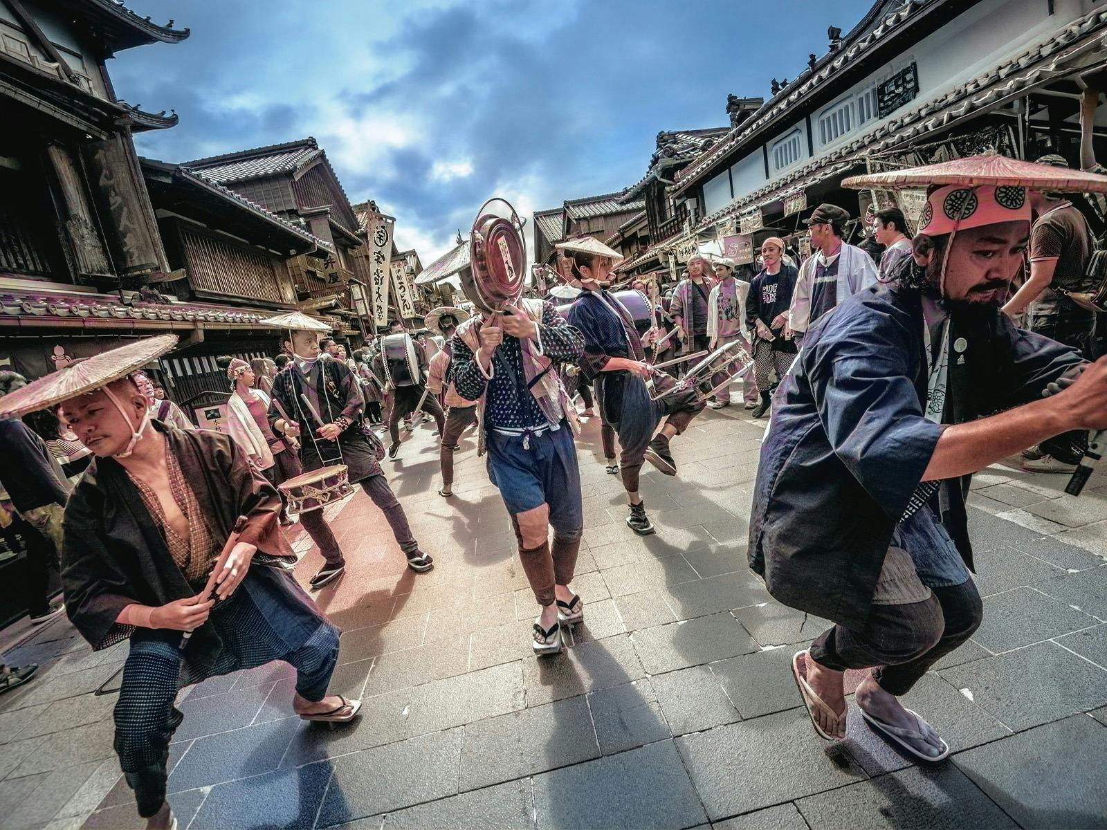 Seppuku Pistols walking down street with hats and props