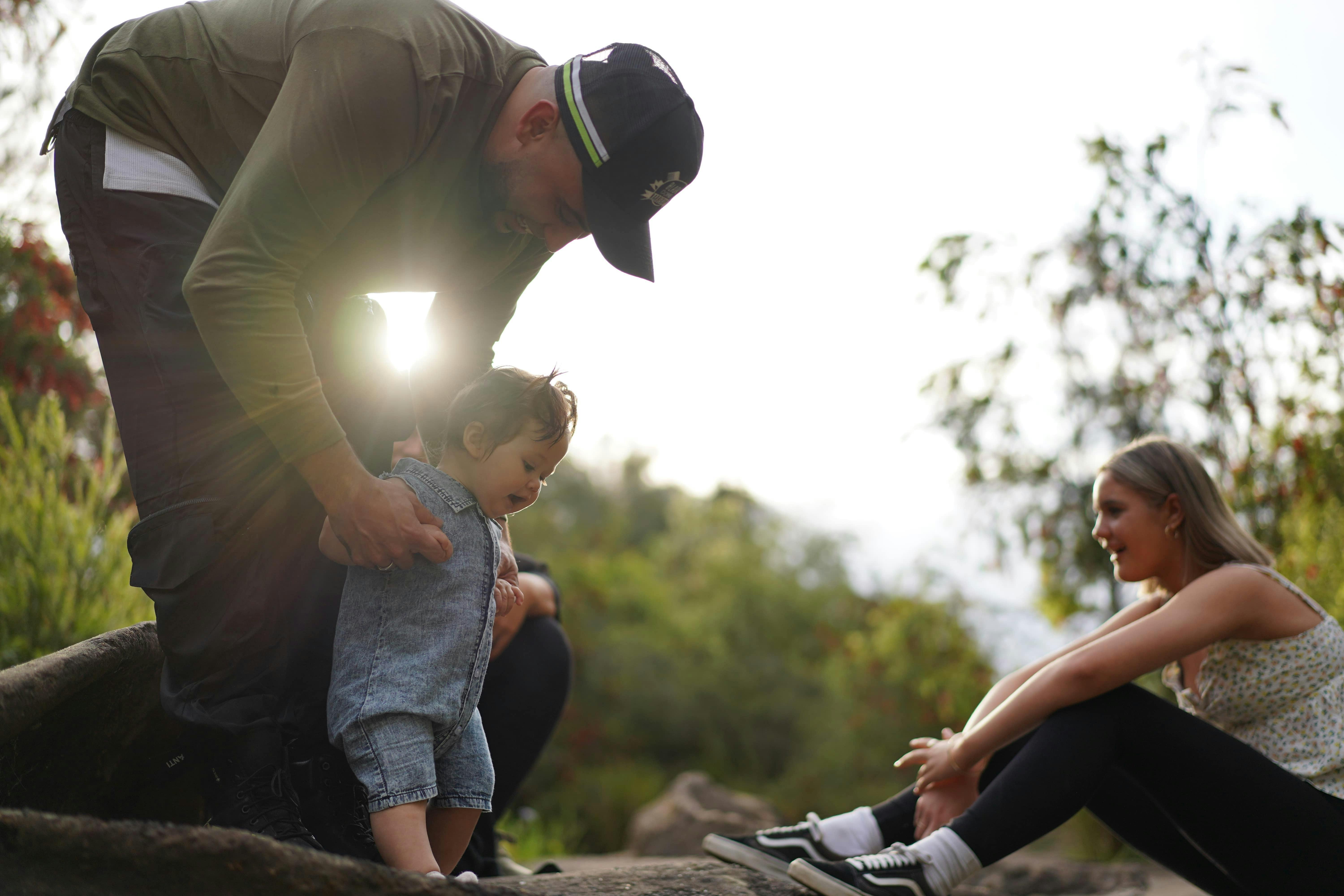 Father and two daughters on river.