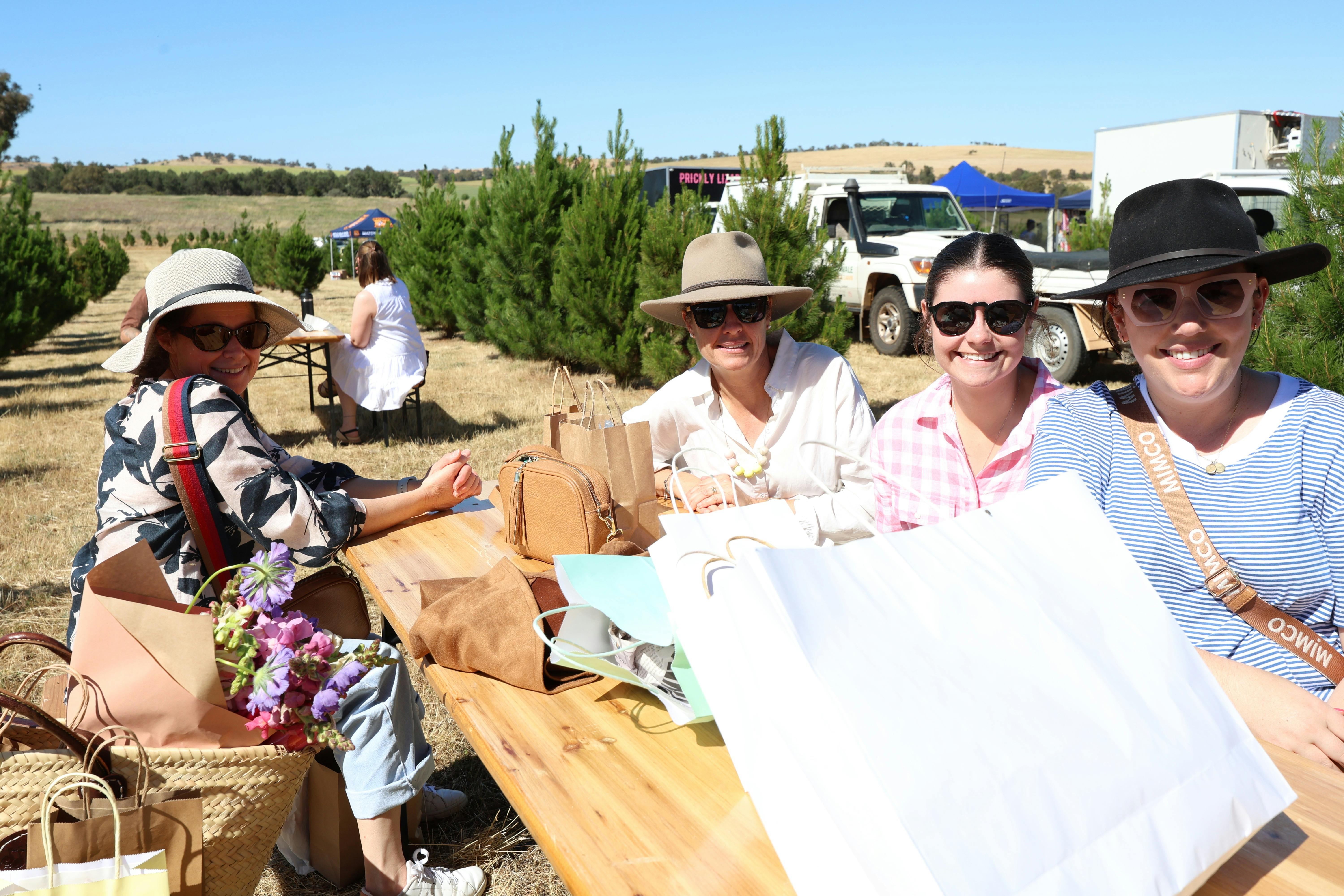 Four ladies seated at a table enjoying their morning at the market