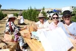 Four ladies seated at a table enjoying their morning at the market