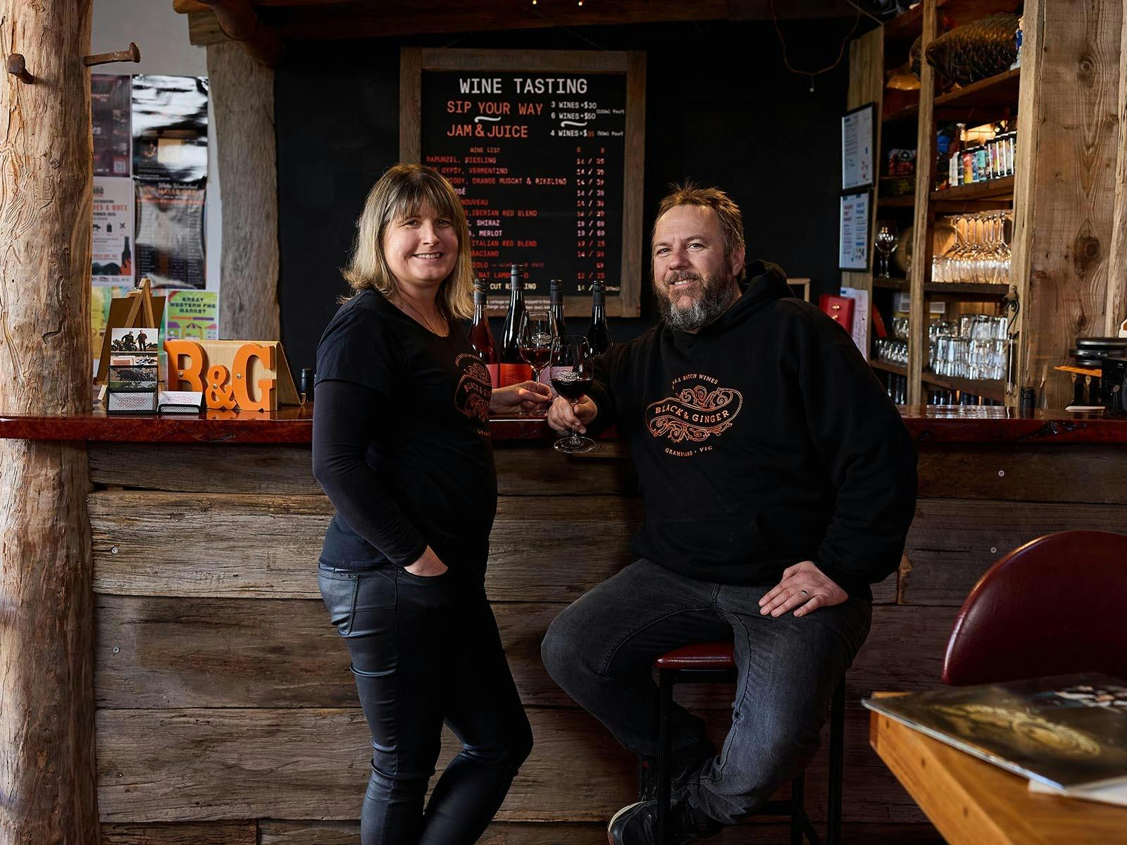Lucy and Hadyn Black in front of the bar at the Black & Ginger Wine Shed
