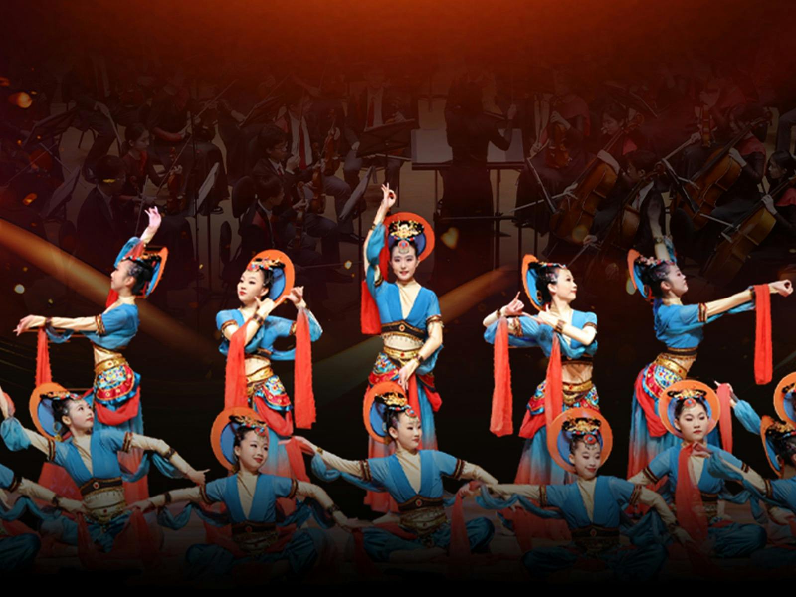 Young performers in traditional Chinese dance costumes performing on stage