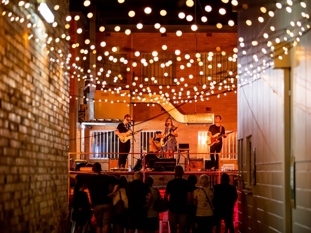 Laneway in Wynnum with string lights and people