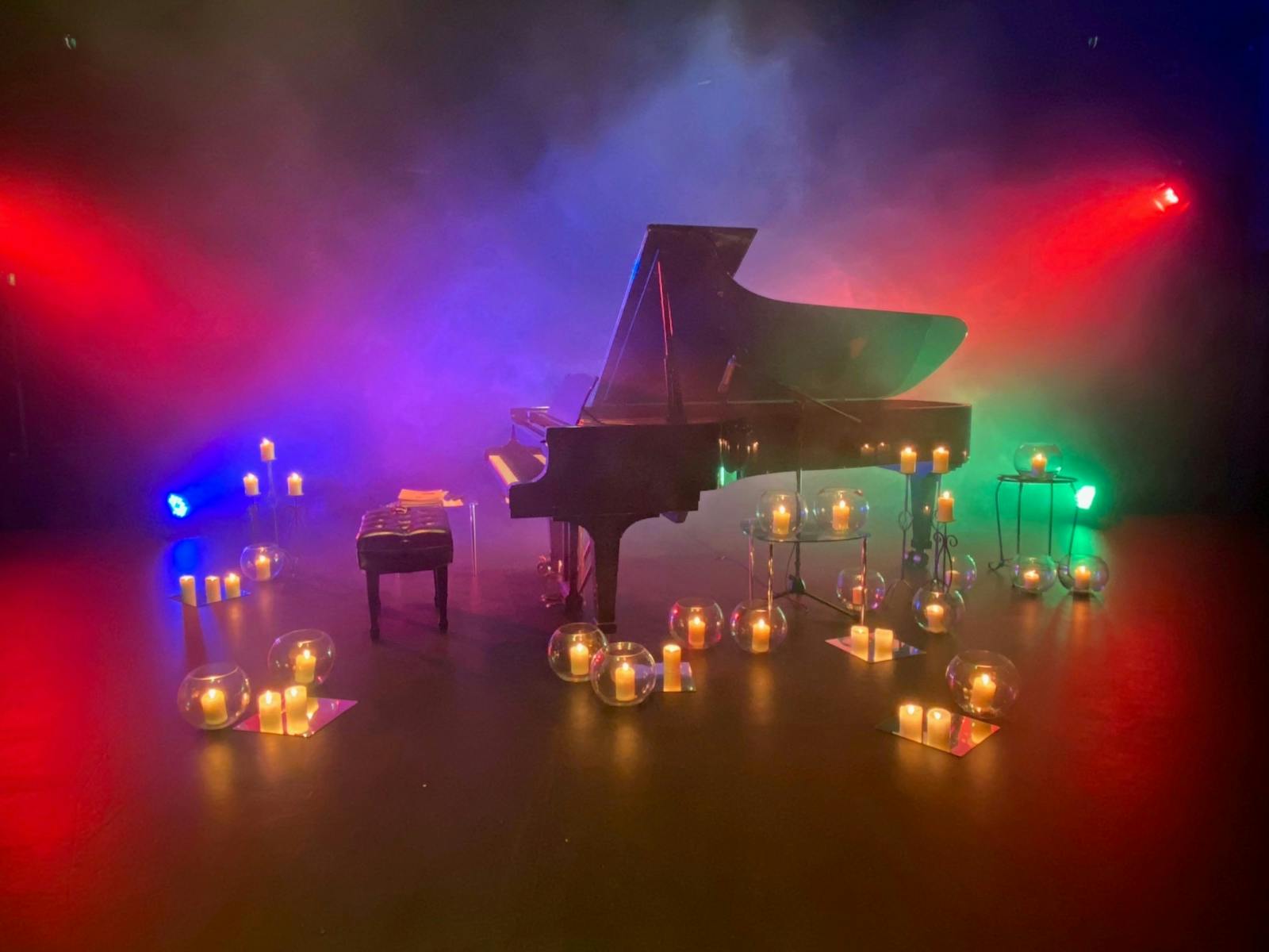 Grand piano, candles, mood lighting, stage, venue set up for Steinway on Stage event